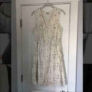 White sundress with pockets, blue and purple accents